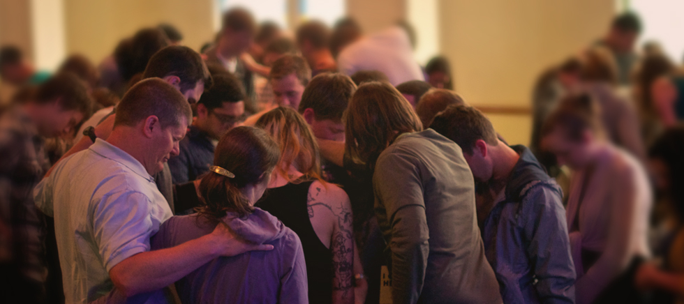 group of people praying in a church